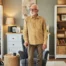 Exploring fall prevention for seniors — an elderly man stands in a safely arranged room.